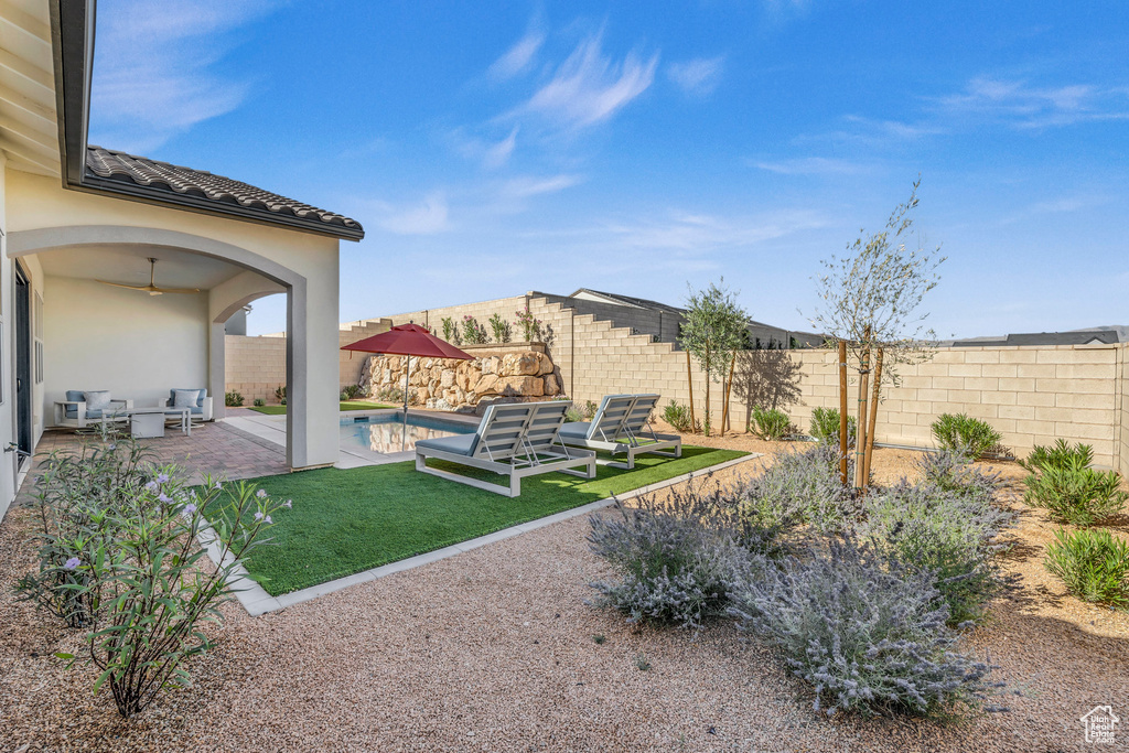 View of yard with a fenced in pool and a patio area