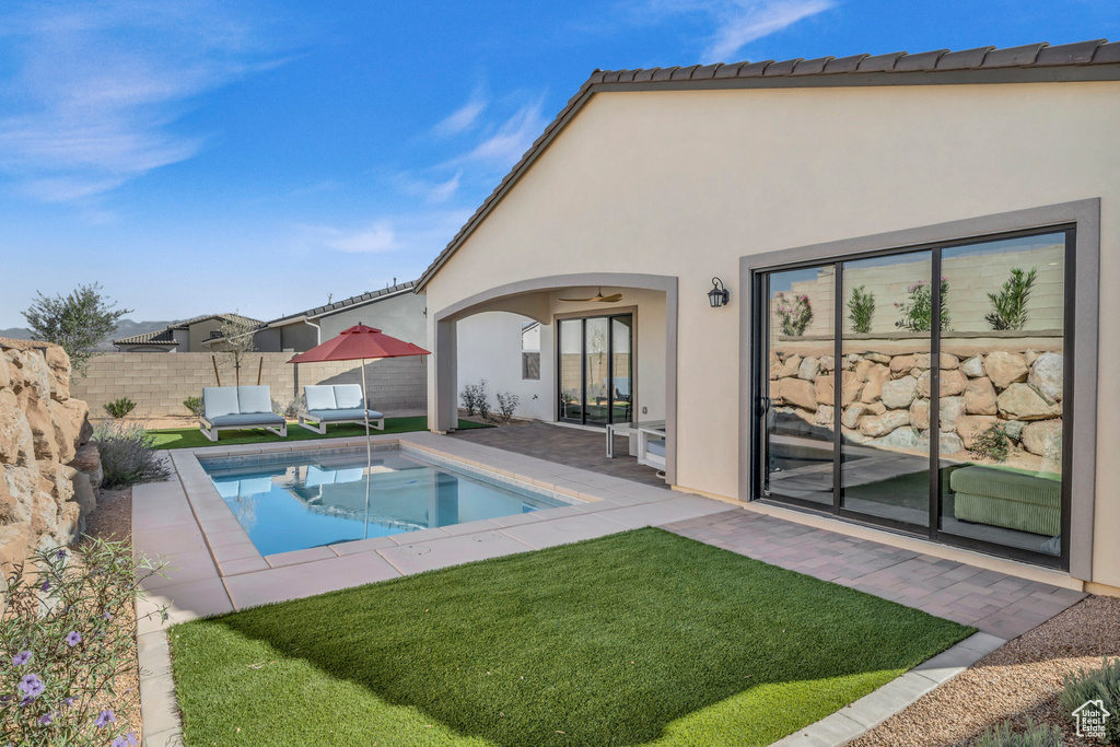 View of swimming pool with a yard and a patio area