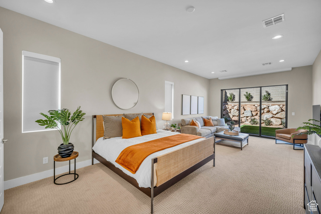 Bedroom with light colored carpet and access to exterior