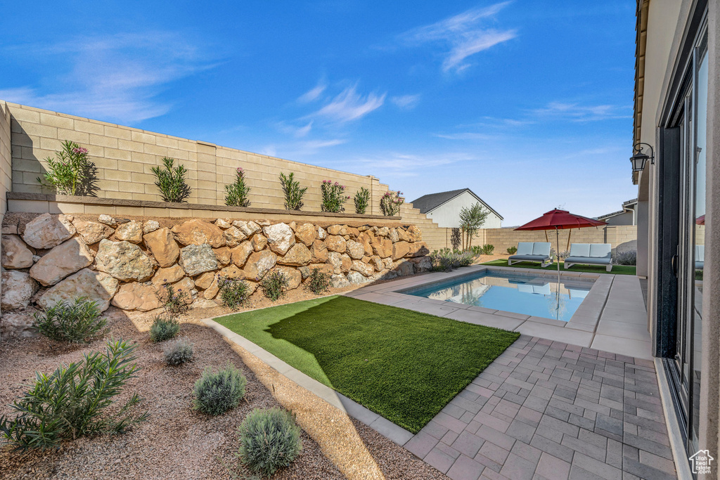 View of pool with a yard and a patio area