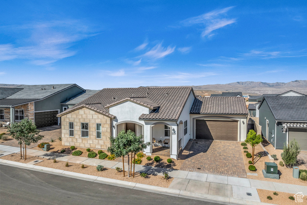 View of front of home featuring a mountain view and a garage