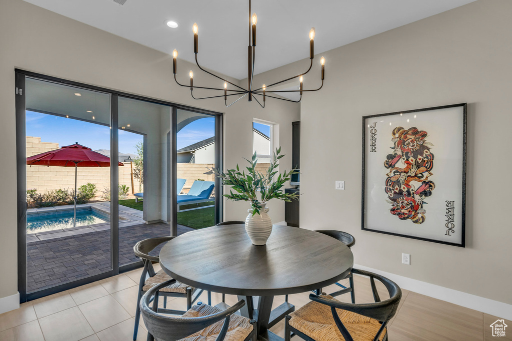 Dining space featuring a chandelier and light tile patterned floors