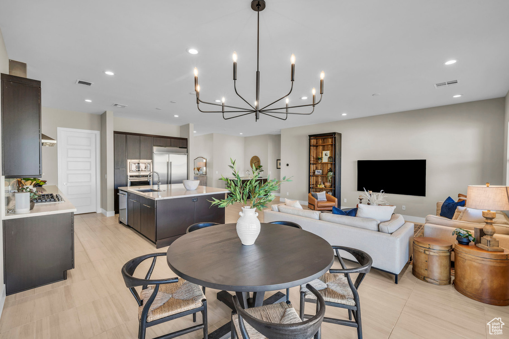 Dining room featuring a chandelier and sink