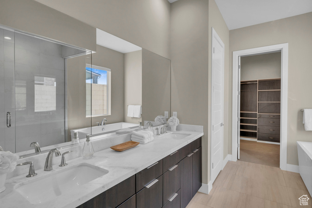 Bathroom with vanity, an enclosed shower, and tile patterned floors