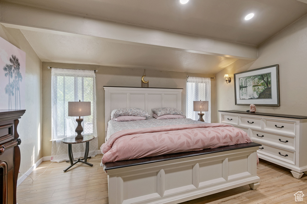 Bedroom with vaulted ceiling and light hardwood / wood-style floors