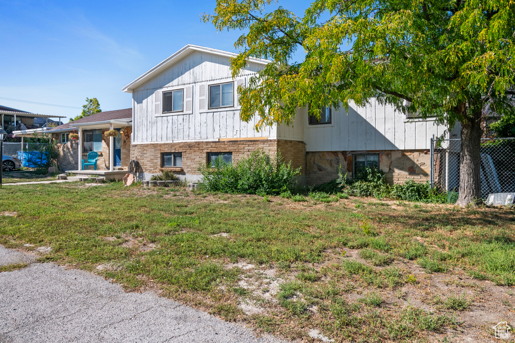 Split level home with a front yard