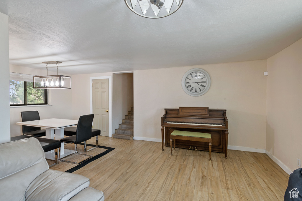 Living room with light hardwood / wood-style floors and a textured ceiling