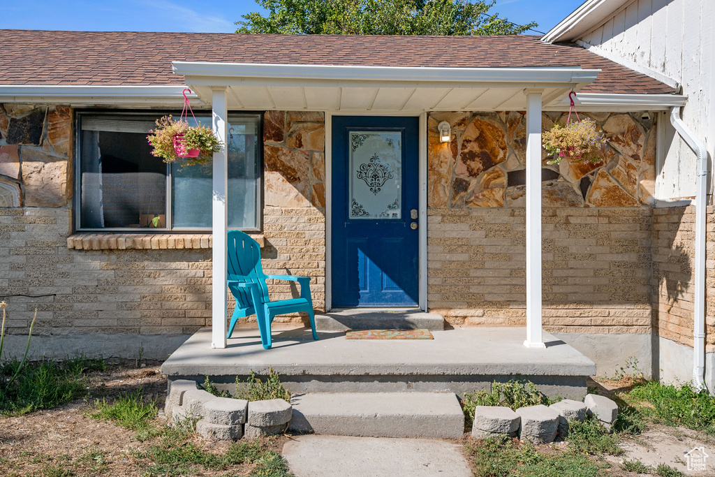 View of exterior entry featuring covered porch