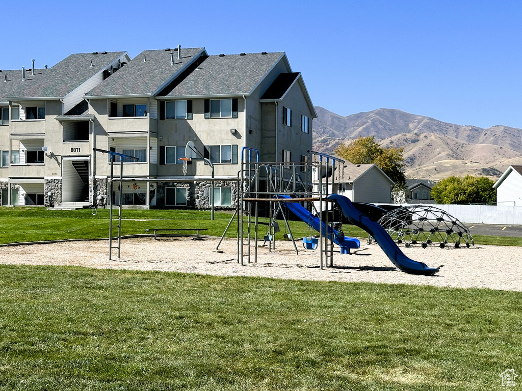 View of play area featuring a lawn and a mountain view