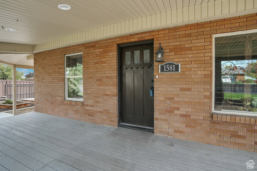 View of exterior entry featuring a deck