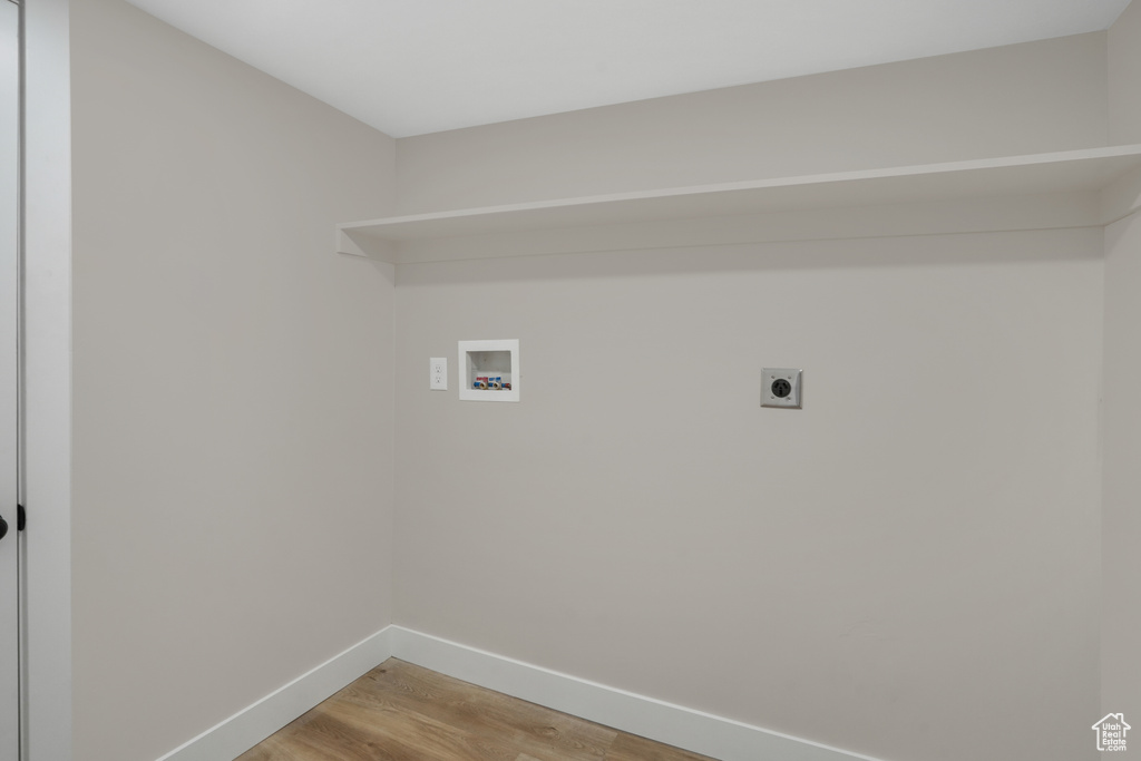 Laundry area featuring washer hookup, hookup for an electric dryer, and hardwood / wood-style flooring