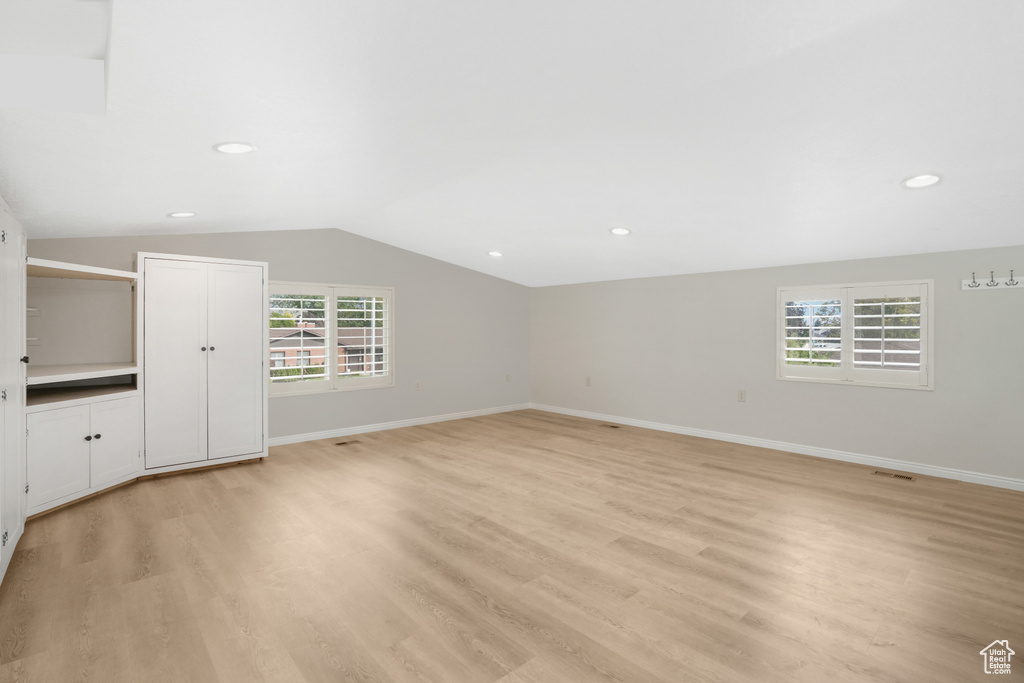 Interior space with light wood-type flooring and lofted ceiling