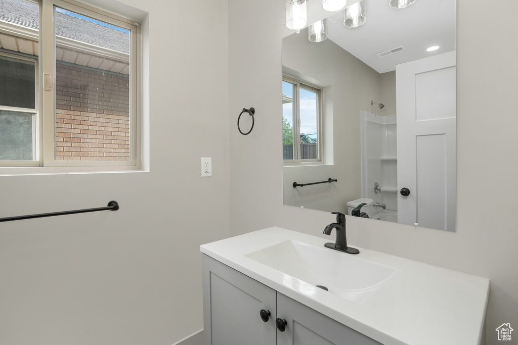 Bathroom featuring a shower and vanity