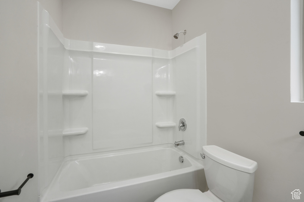 Bathroom featuring toilet and  shower combination