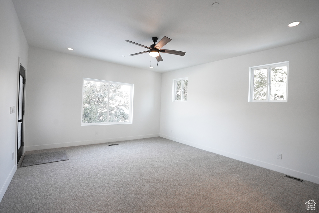 Unfurnished room with carpet floors and ceiling fan