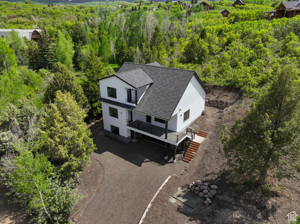 View from above of property featuring a heavily wooded area