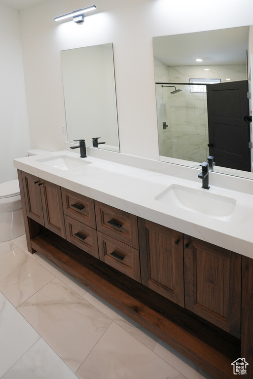 Bathroom featuring vanity, toilet, and walk in shower