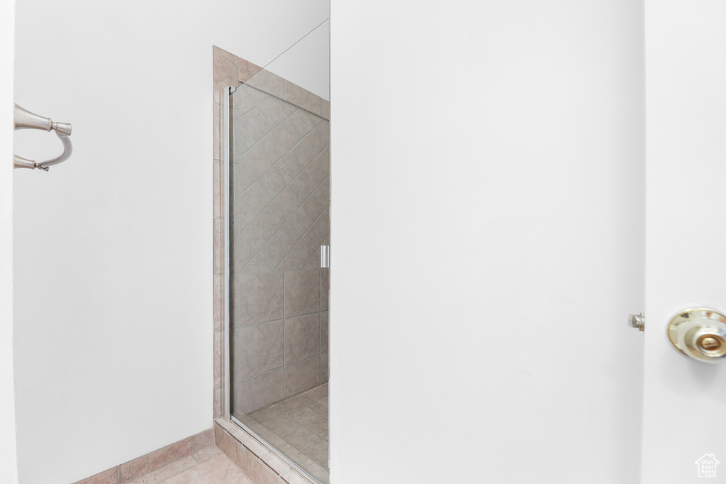 Bathroom featuring tile patterned flooring and an enclosed shower