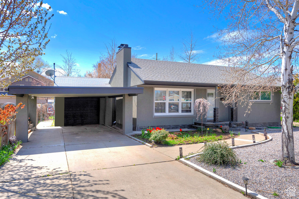 Single story home featuring a carport