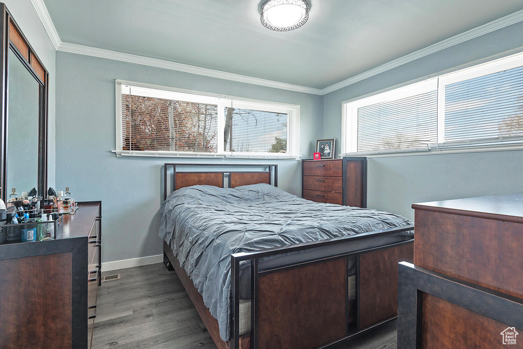 Bedroom featuring crown molding and hardwood / wood-style floors