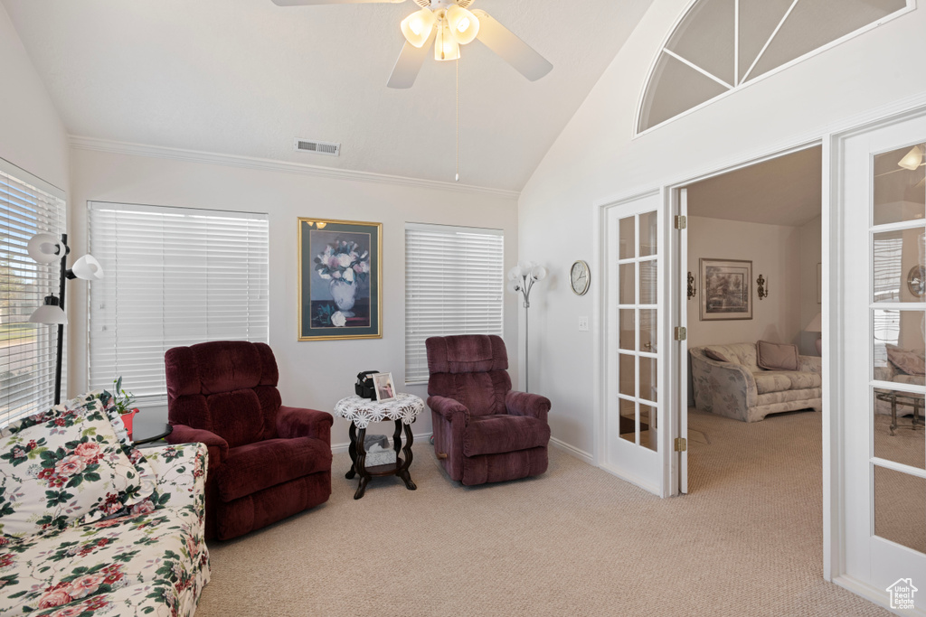 Sitting room featuring ceiling fan, light colored carpet, and vaulted ceiling
