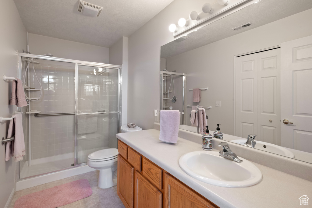 Bathroom with walk in shower, vanity, and toilet