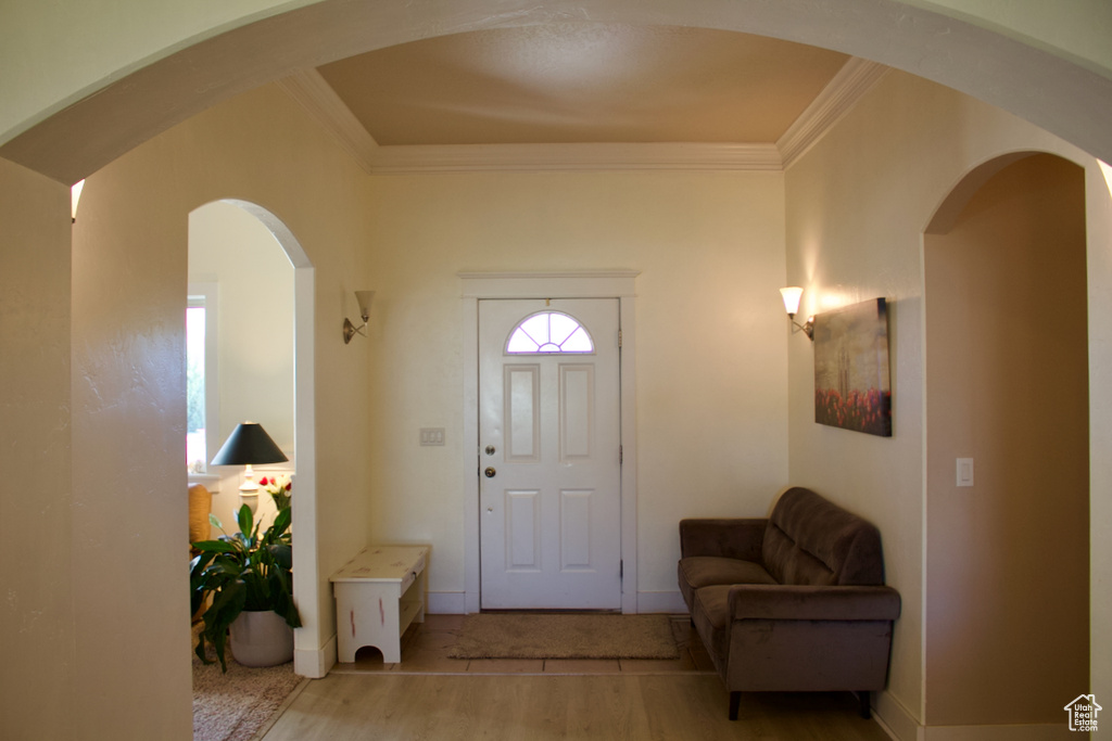 Entrance foyer featuring light hardwood / wood-style flooring and ornamental molding