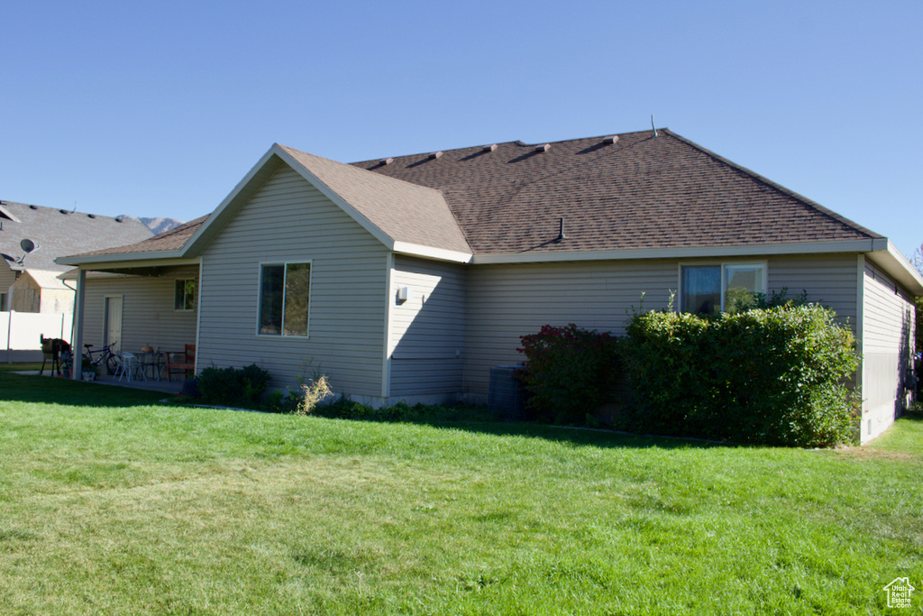 View of side of home with a lawn