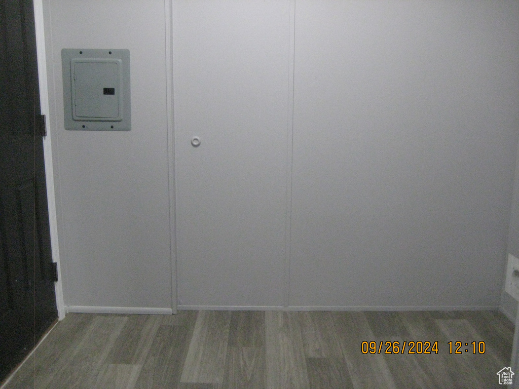 Room details with hardwood / wood-style floors and electric panel