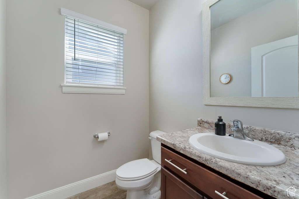 Bathroom featuring vanity, tile patterned flooring, and toilet