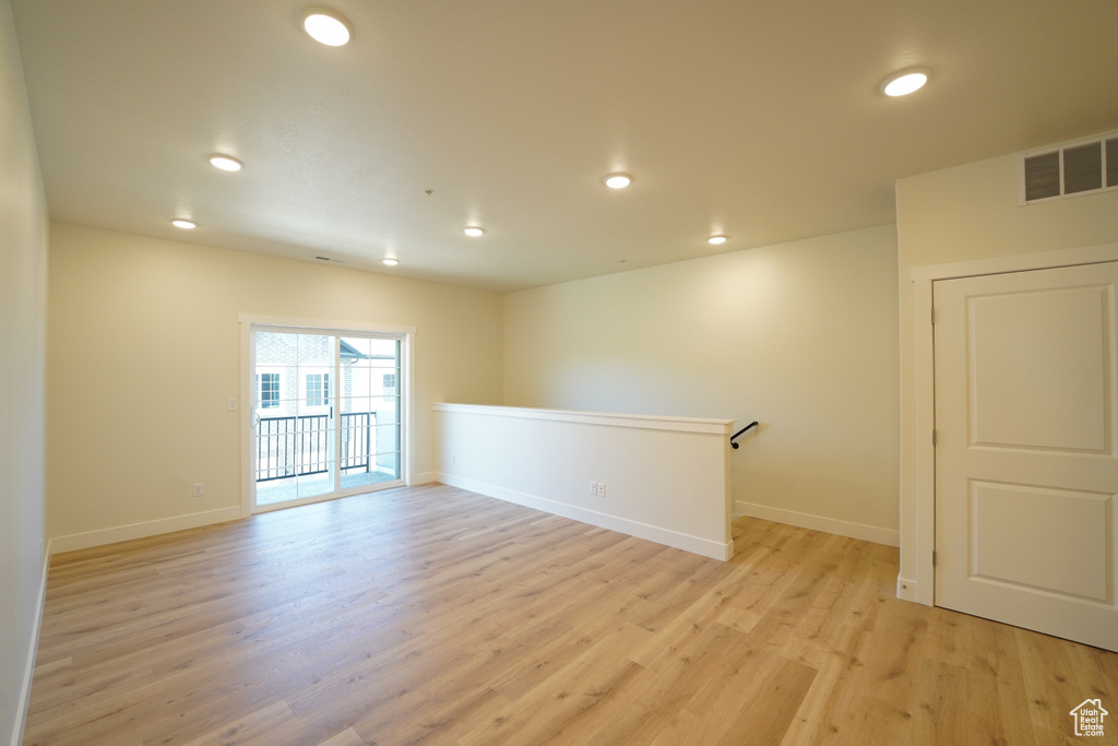 Empty room with light hardwood / wood-style flooring