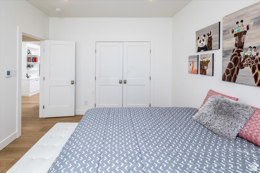 Bedroom with light hardwood / wood-style floors