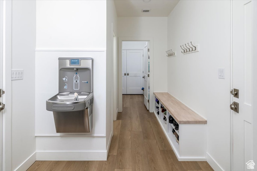 Hallway with hardwood / wood-style floors