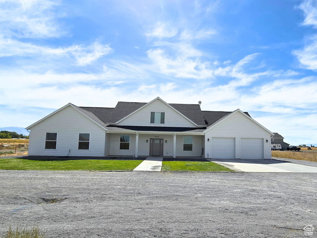 View of front of home featuring a garage and a front lawn