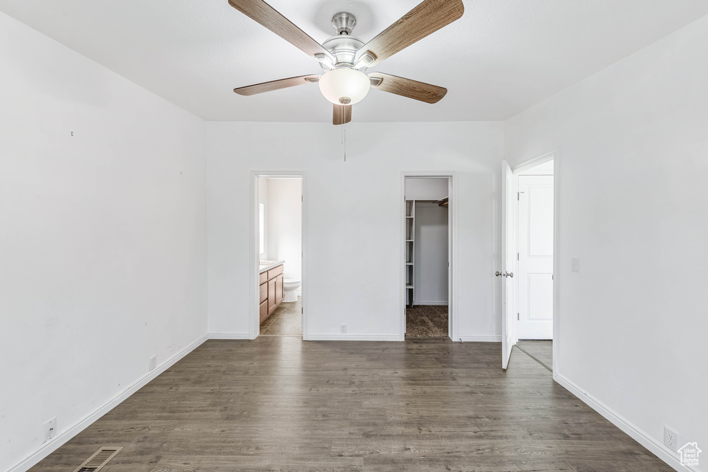 Unfurnished room with ceiling fan and dark hardwood / wood-style flooring