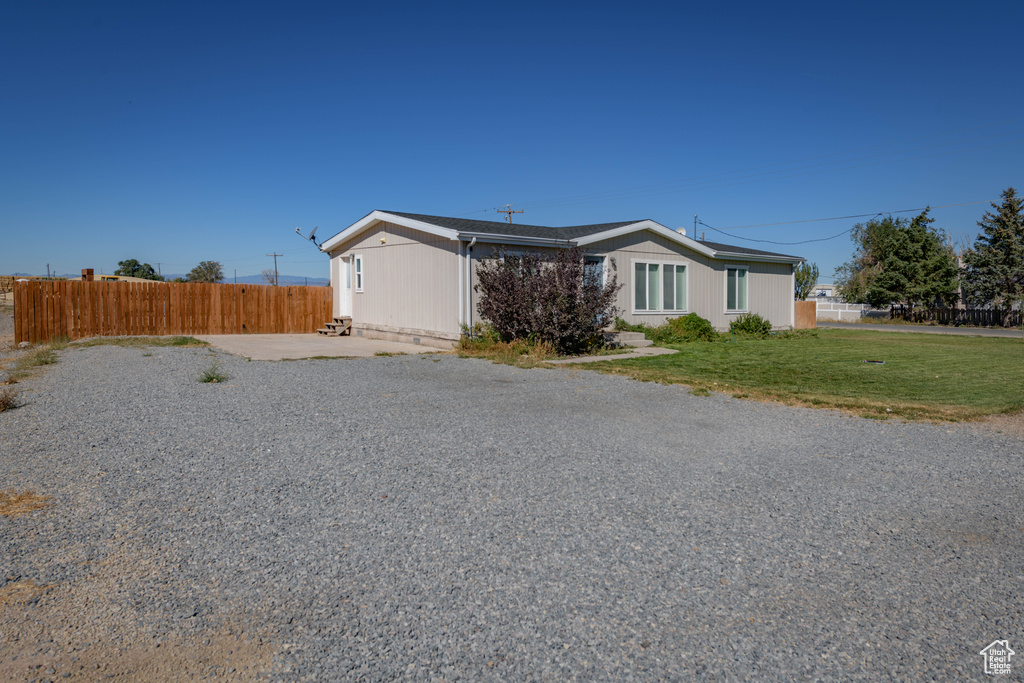 View of side of home with a yard