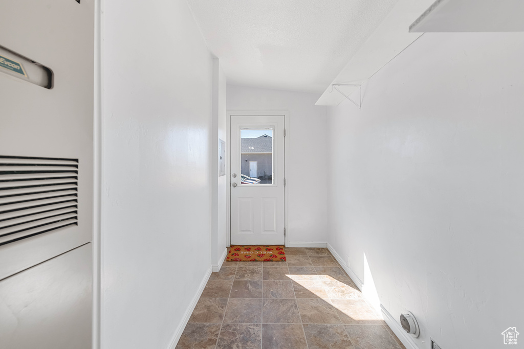 Doorway to outside with vaulted ceiling