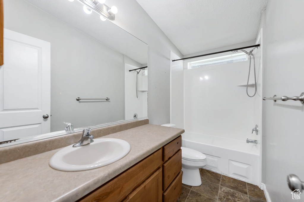 Full bathroom featuring  shower combination, vanity, and toilet