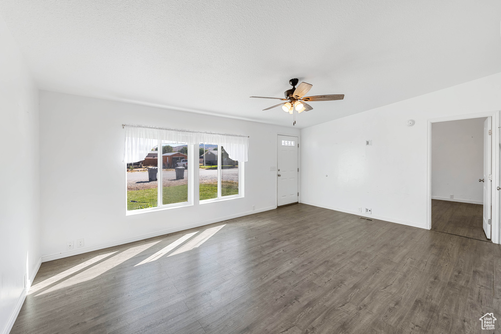 Unfurnished room with dark hardwood / wood-style floors and ceiling fan