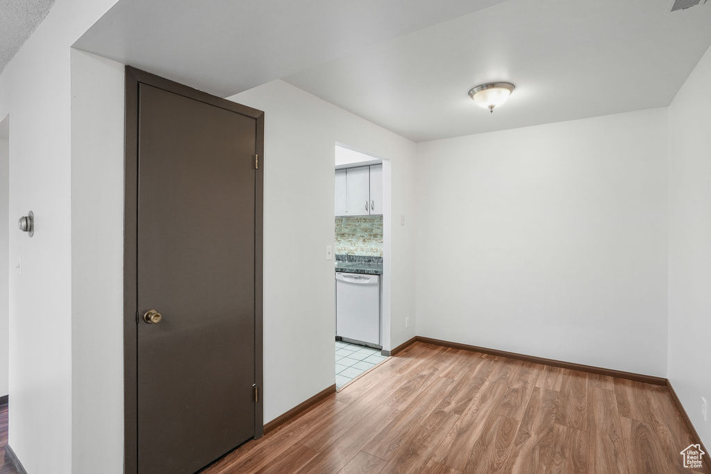 Empty room with light hardwood / wood-style flooring