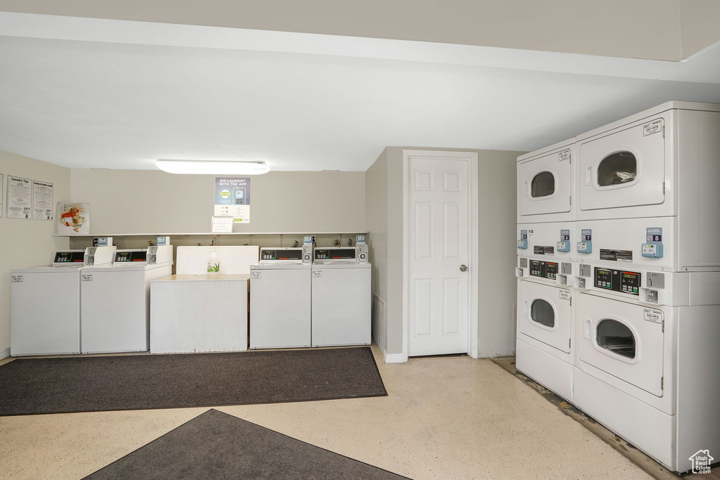 Laundry room with stacked washing maching and dryer and independent washer and dryer