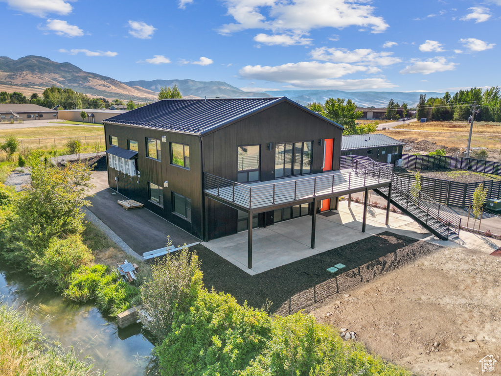 Back of property with a mountain view
