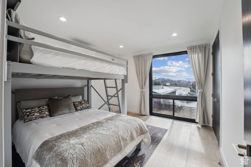 Bedroom with light hardwood / wood-style flooring