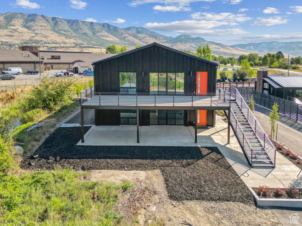 Rear view of property with a patio and a mountain view