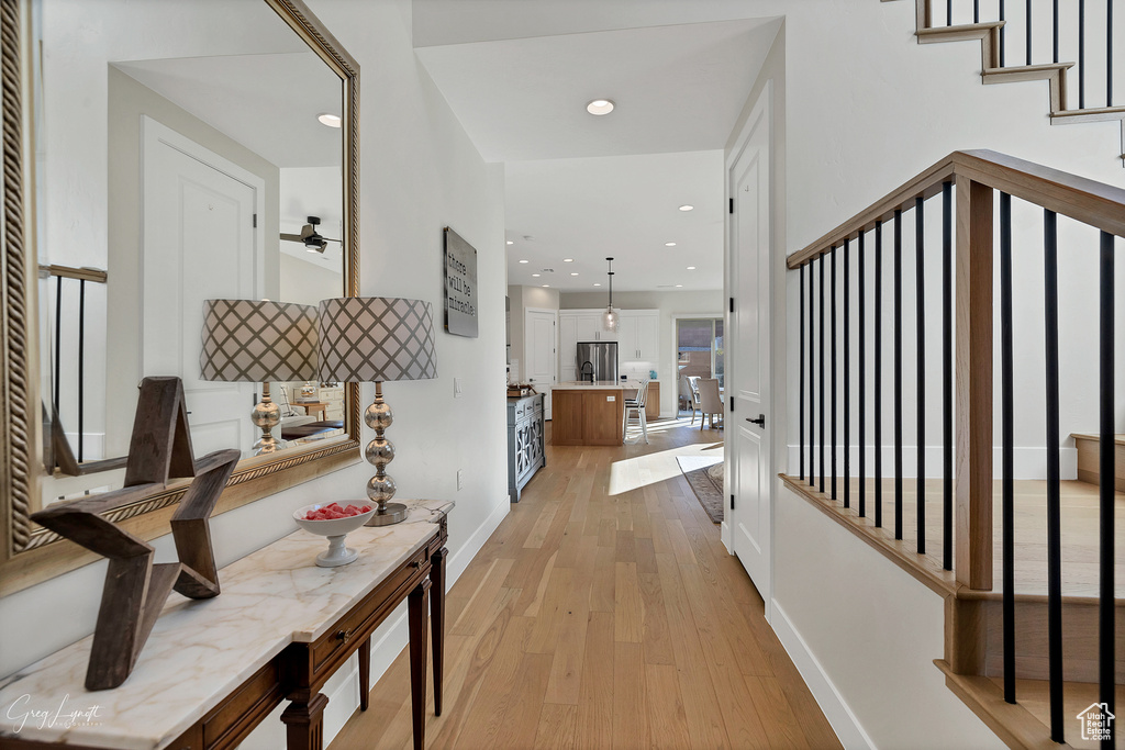 Hall with light hardwood / wood-style flooring