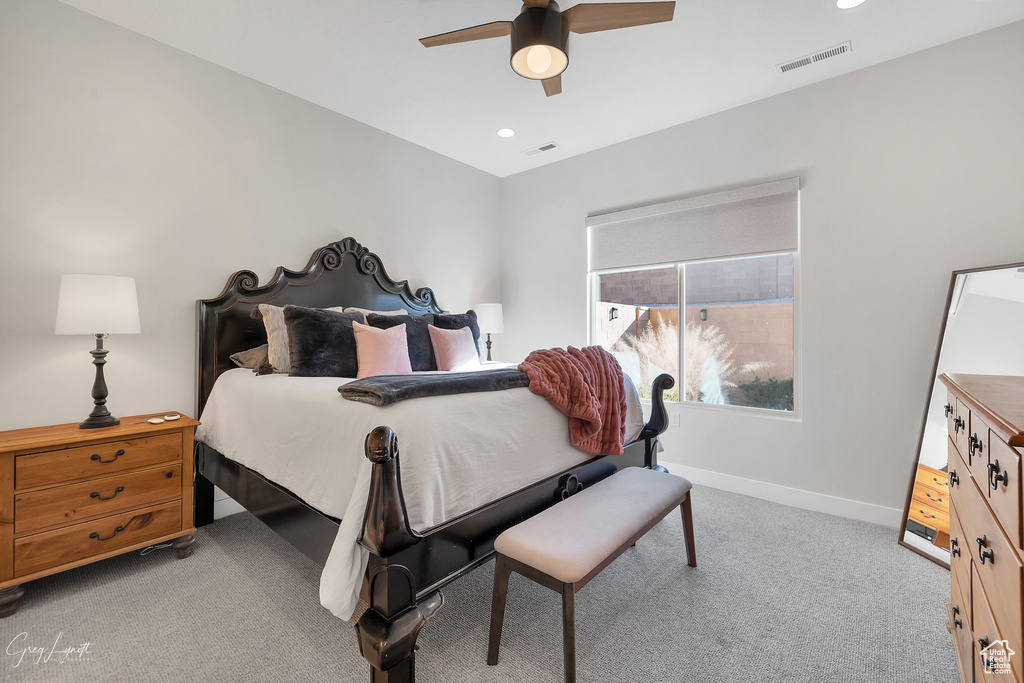 Carpeted bedroom with ceiling fan