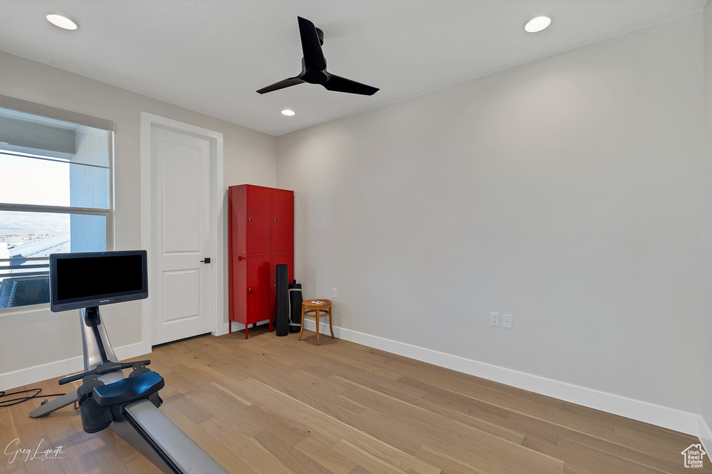 Workout room featuring light wood-type flooring and ceiling fan