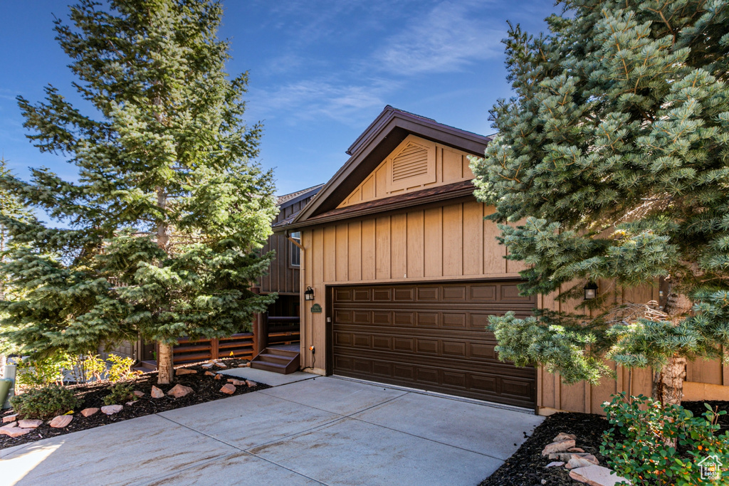 View of side of property featuring a garage