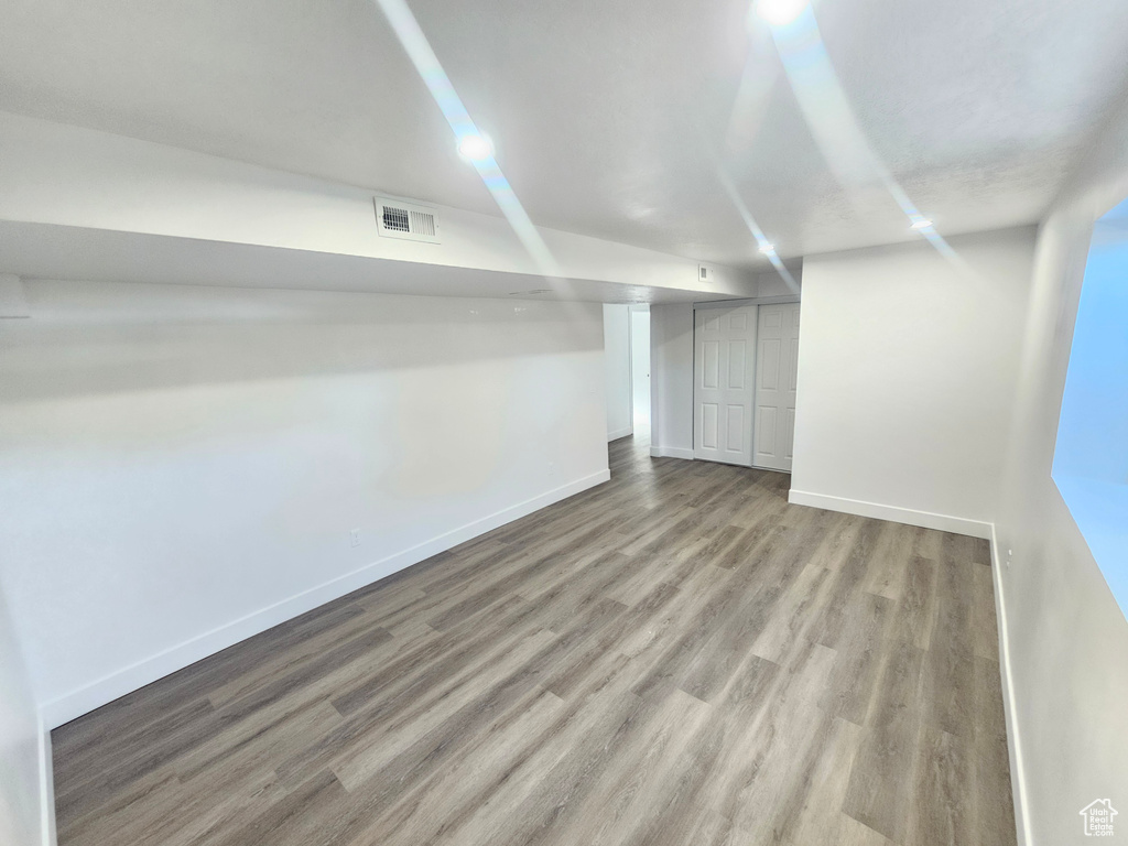 Basement with light hardwood / wood-style floors