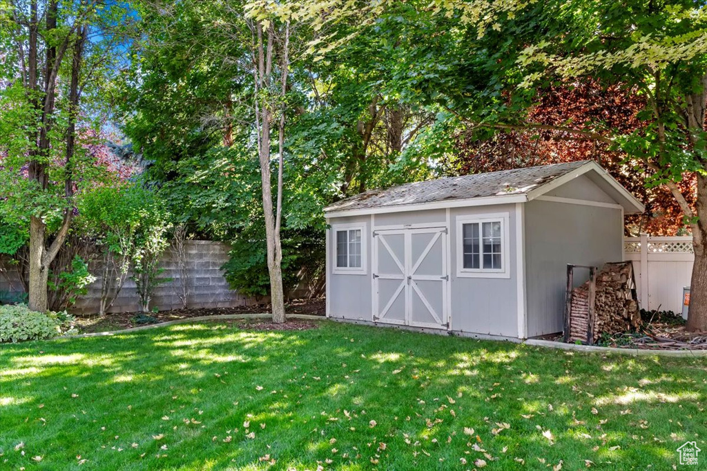 View of outdoor structure featuring a yard